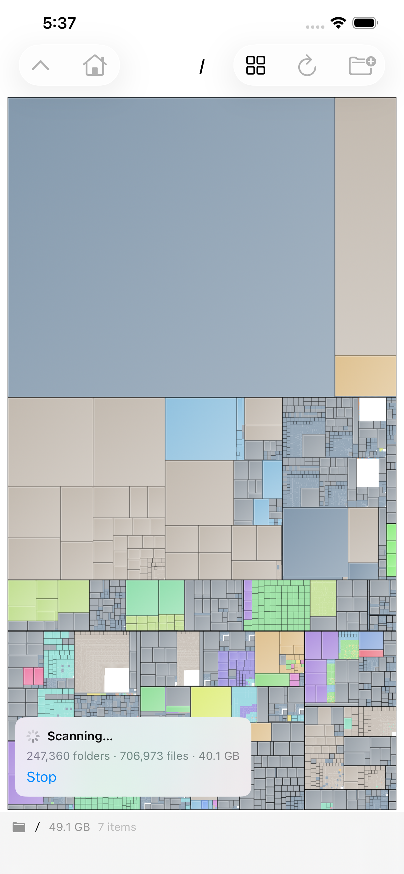 A scan in progress on iPhone &mdash; the whole volume drawn as a treemap where every rectangle is a file sized by the bytes it takes, with a scanning card counting 247,360 folders and 706,973 files at 40.1 GB so far and a Stop button