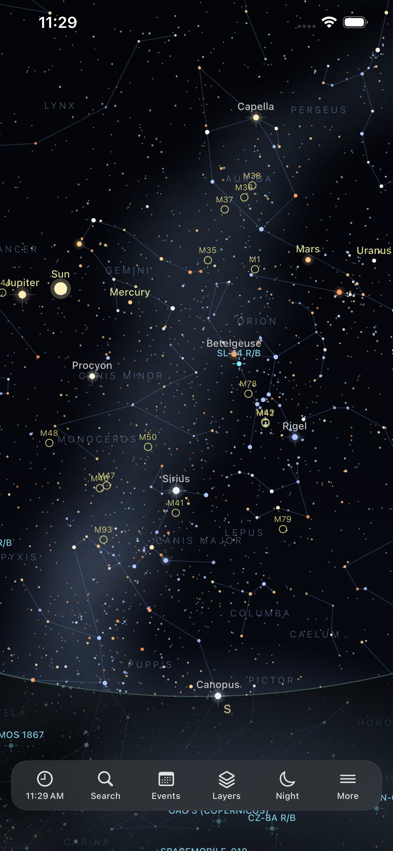 The sky chart on iPhone &mdash; Gemini, Orion, Canis Major, Monoceros, Columba and Puppis drawn with their constellation lines, the Sun, Mercury, Mars, Jupiter and Uranus marked along the ecliptic, named stars from Capella and Betelgeuse to Sirius, Procyon, Rigel and Canopus, Messier objects circled from M1 to M93, and satellite tracks crossing the field