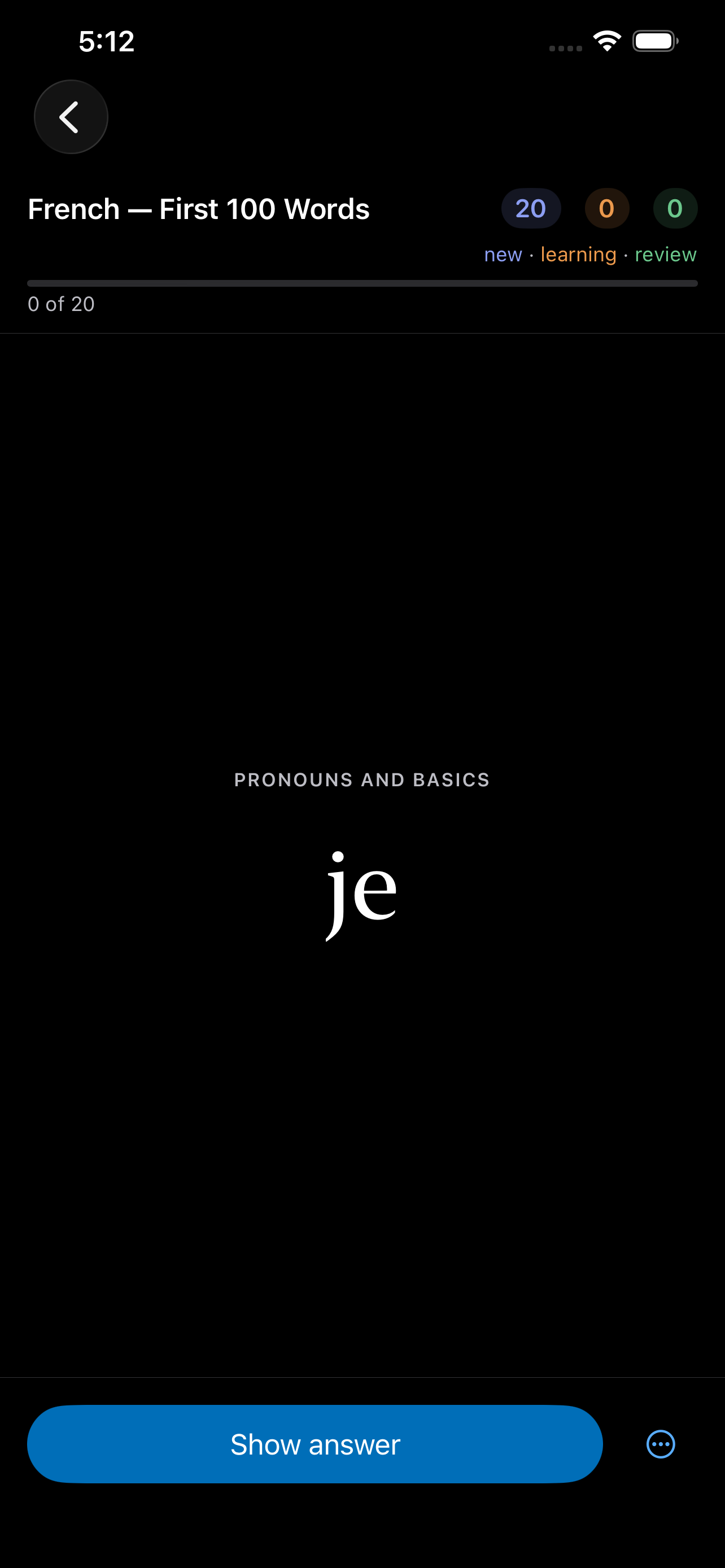 A card on iPhone &mdash; the section PRONOUNS AND BASICS above the single French word &lsquo;je&rsquo; set large on black with nothing else on screen, and Show answer along the bottom