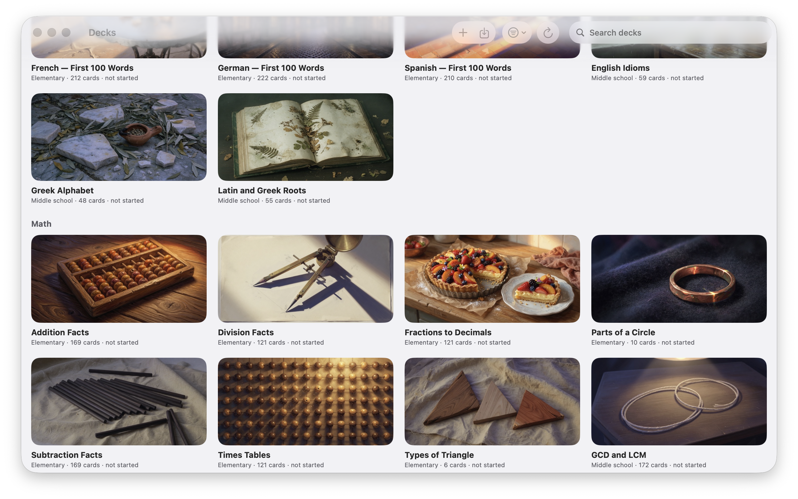 The deck library — illustrated decks grouped by subject, each showing its level, card count, and progress, from first-hundred-words language decks to Greek Alphabet, Times Tables, and Types of Triangle
