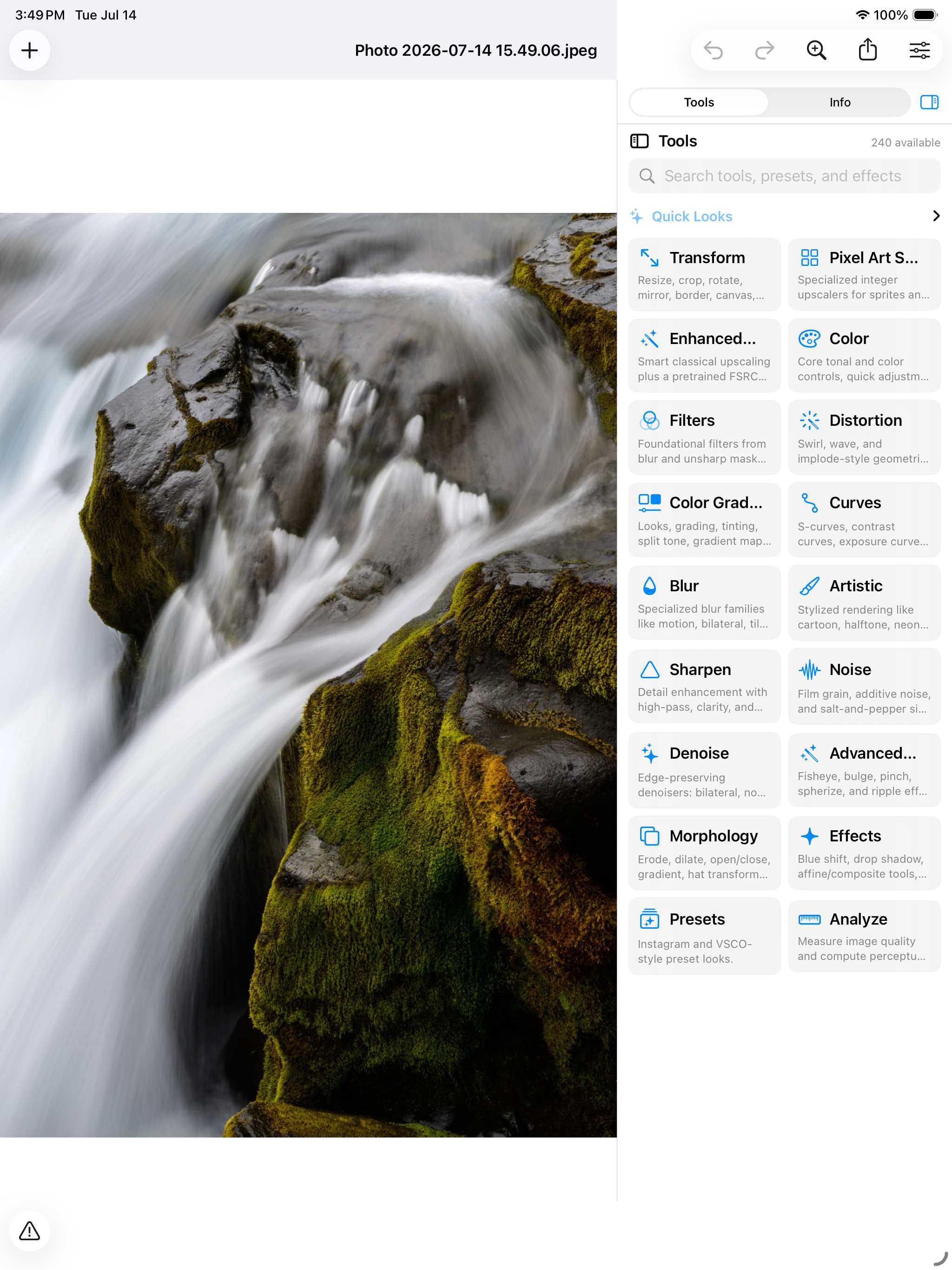 An image open on iPad &mdash; a long-exposure photograph of water pouring over mossed rock beside the tool inspector, its 240 tools grouped as Transform, Pixel Art Scaling, Enhanced Upscaling, Color, Filters, Distortion, Color Grading, Curves, Blur, Artistic, Sharpen, Noise, Denoise, Advanced Distortion, Morphology, Effects, Presets and Analyze, each with a line on what it holds